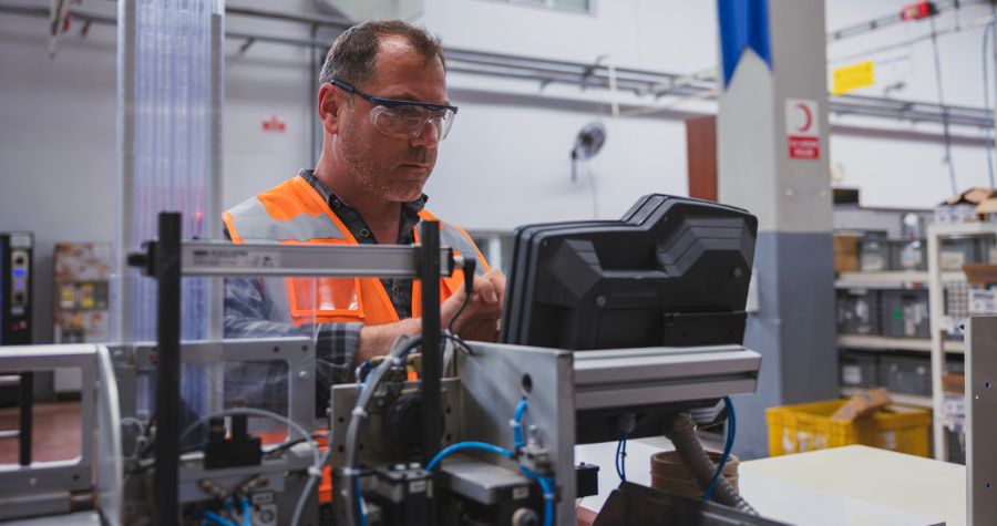Man looking at machinery in Manufacturing plant